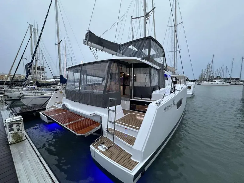 Slide: The Image of 2025 Fountaine Pajot Astrea 42 catamaran docked in a marina, featuring modern design. - 7