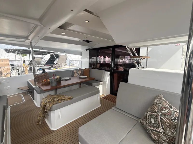 Slide: The Image of 2025 Fountaine Pajot Astrea 42 yacht interior with modern seating and dining area. - 9