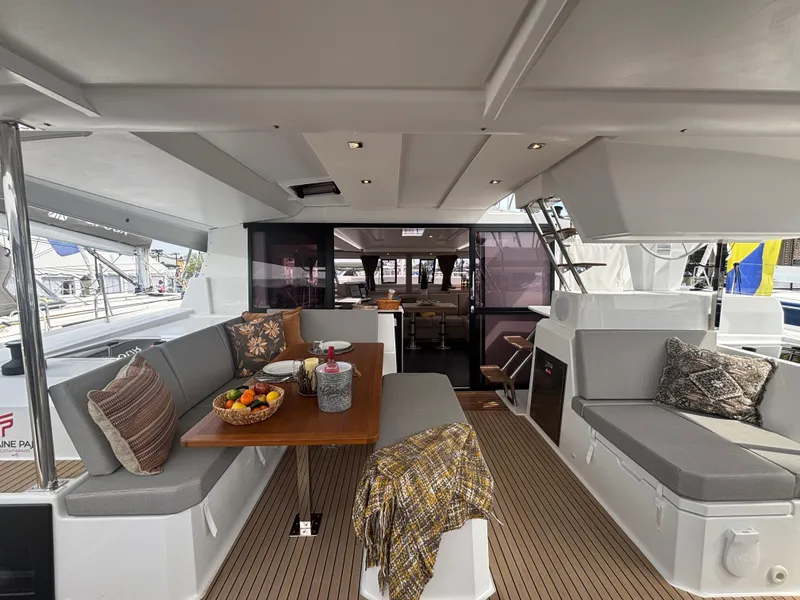 Slide: The Image of 2025 Fountaine Pajot Astrea 42 yacht interior with elegant seating and dining area. - 11
