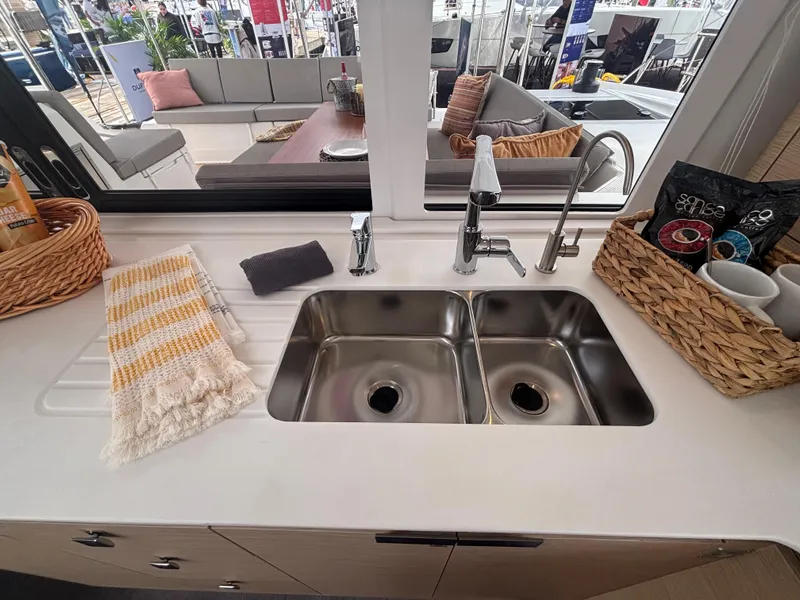 Slide: The Image of Modern kitchen sink area on 2025 Fountaine Pajot Astrea 42 catamaran, featuring dual sinks and stylish decor. - 14