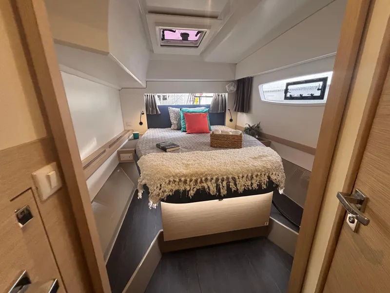 Slide: The Image of Luxurious cabin interior of 2025 Fountaine Pajot Astrea 42 catamaran, featuring cozy bedding and modern design. - 18