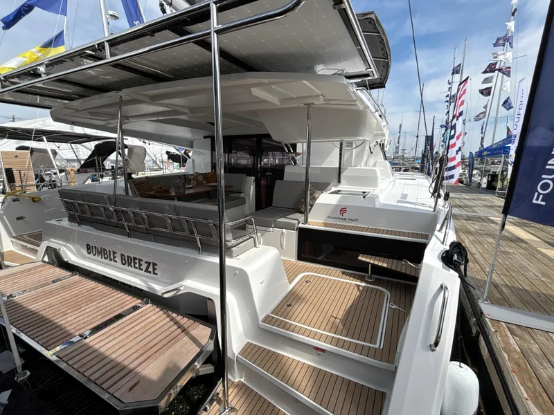 Slide: The Image of 2025 Fountaine Pajot Astrea 42 catamaran docked, showcasing spacious deck and modern design. - 25