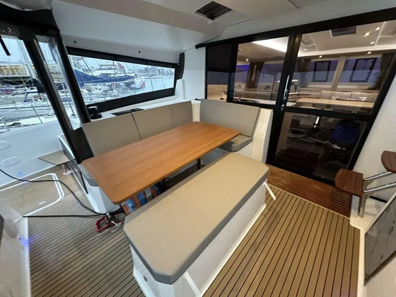 Slide: The Image of 2025 Fountaine Pajot Astrea 42 yacht interior with elegant seating and wooden table. - 26