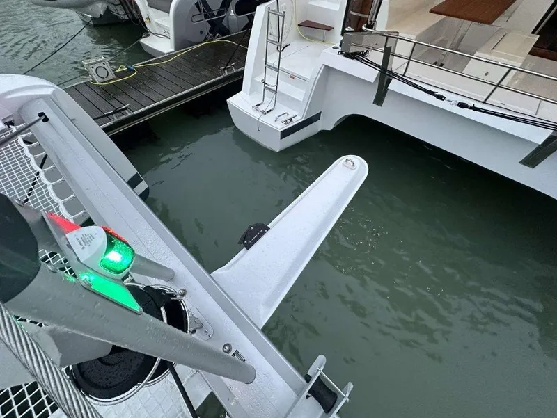 Slide: The Image of Fountaine Pajot Astrea 42 catamaran, 2025 model, docked with visible stern and boarding ladder. - 28