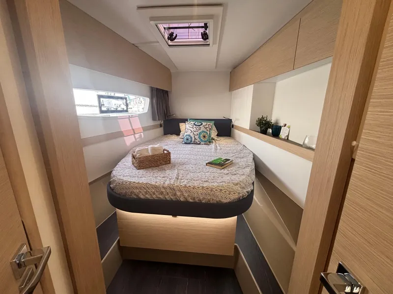Slide: The Image of Luxurious cabin interior of 2025 Fountaine Pajot Astrea 42 catamaran, featuring cozy bed and modern decor. - 36
