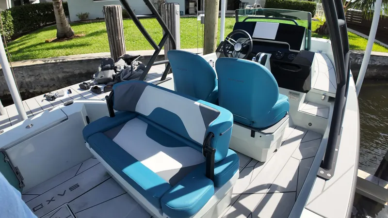 Slide: The Image of 2022 Saxdor SX200 boat interior with blue and white seating, steering wheel, and modern design. - 10