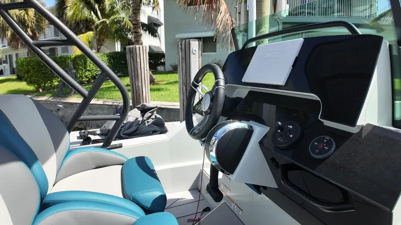 Slide: The Image of 2022 Saxdor SX200 boat interior with steering wheel and dashboard controls. - 12