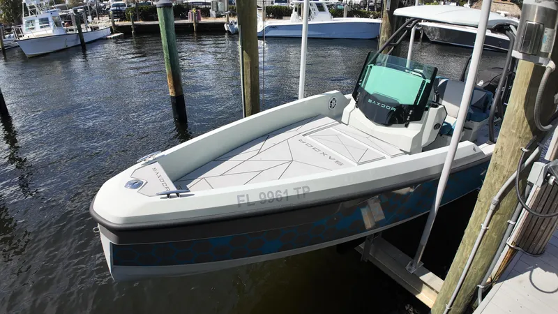 Slide: The Image of 2022 Saxdor SX200 boat docked at marina, featuring sleek design and modern console. - 14