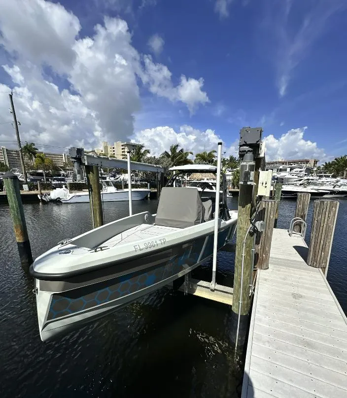 Slide: The Image of 2022 Saxdor SX200 boat docked at marina under a clear blue sky. - 15