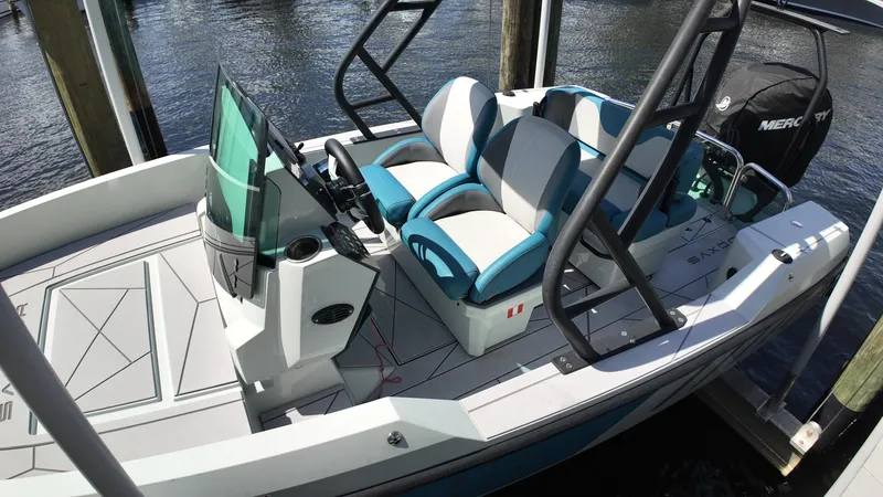Slide: The Image of 2022 Saxdor SX200 boat with modern seating and sleek design, docked by the water. - 6