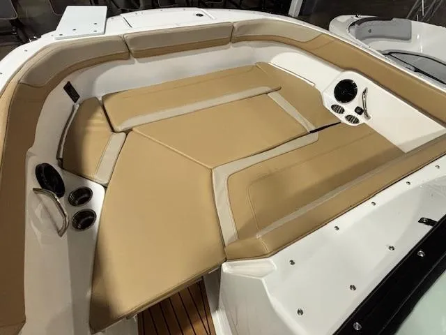 Slide: The Image of 2025 Bayliner T22 SC boat interior with tan seating and cup holders. - 27