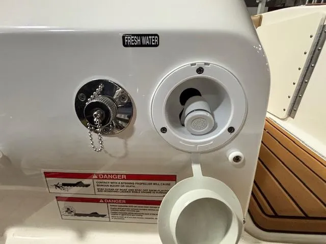 Slide: The Image of Fresh water inlet on 2025 Bayliner T22 SC boat with safety warnings. - 8