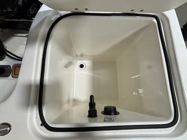 Slide: The Image of 2025 Bayliner T22 SC boat storage compartment with drainage and fittings. - 11