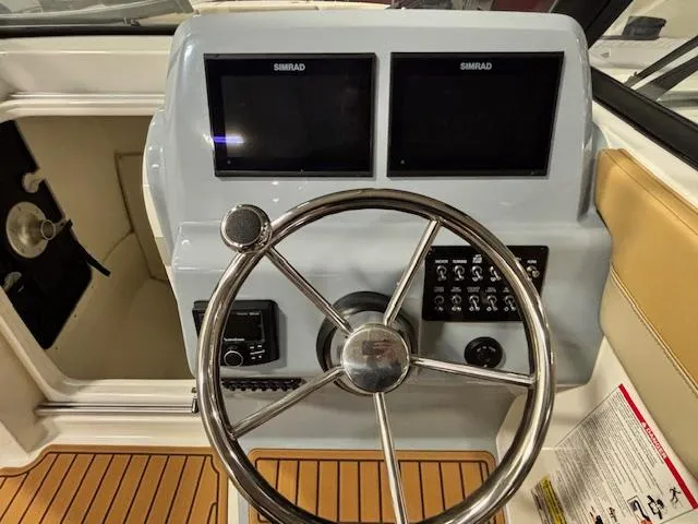Slide: The Image of 2025 Bayliner T22 SC helm with dual Simrad displays and modern steering wheel. - 17