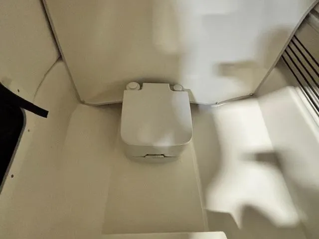 Slide: The Image of 2025 Bayliner T22 SC interior with compact marine toilet. - 24