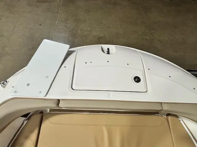 Slide: The Image of 2025 Bayliner T22 SC boat interior, featuring white and beige seating and storage compartment. - 28
