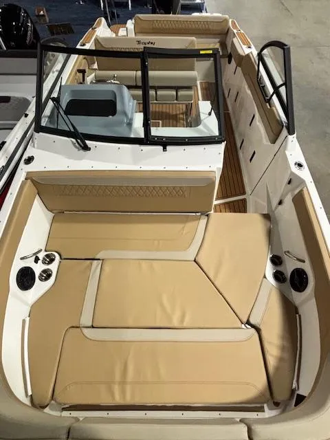 Slide: The Image of 2025 Bayliner T22 SC boat interior with beige seating and modern design. - 30