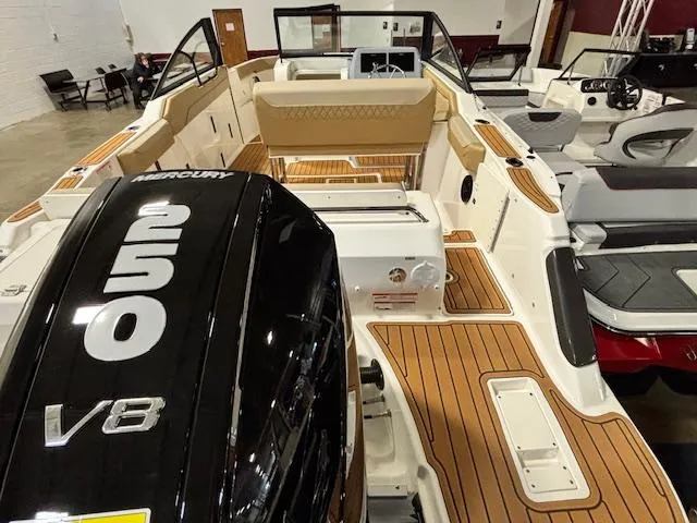 Slide: The Image of 2025 Bayliner T22 SC boat with Mercury V8 engine, featuring spacious seating and teak flooring. - 7