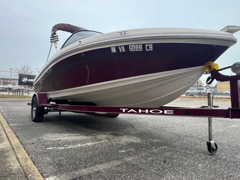 Slide: The Image of 2016 Tahoe 450 TF boat on trailer in parking lot. - 10