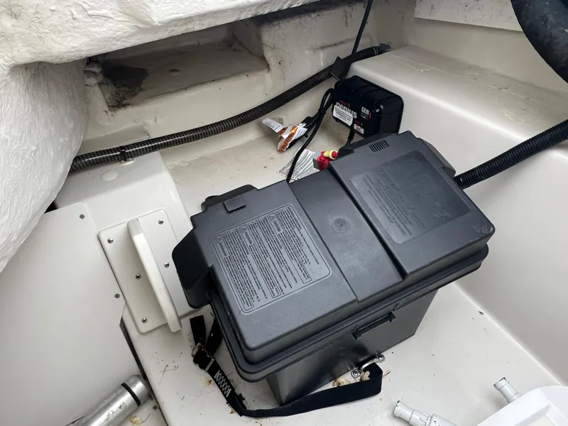 Slide: The Image of 2016 Tahoe 450 TF boat battery compartment with secured battery box. - 24