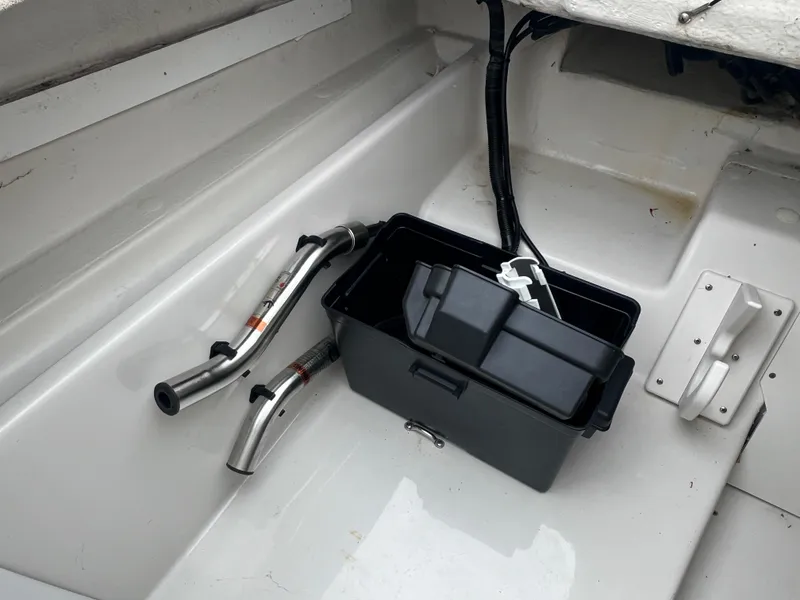 Slide: The Image of 2016 Tahoe 450 TF boat interior with storage box and metal rods. - 25