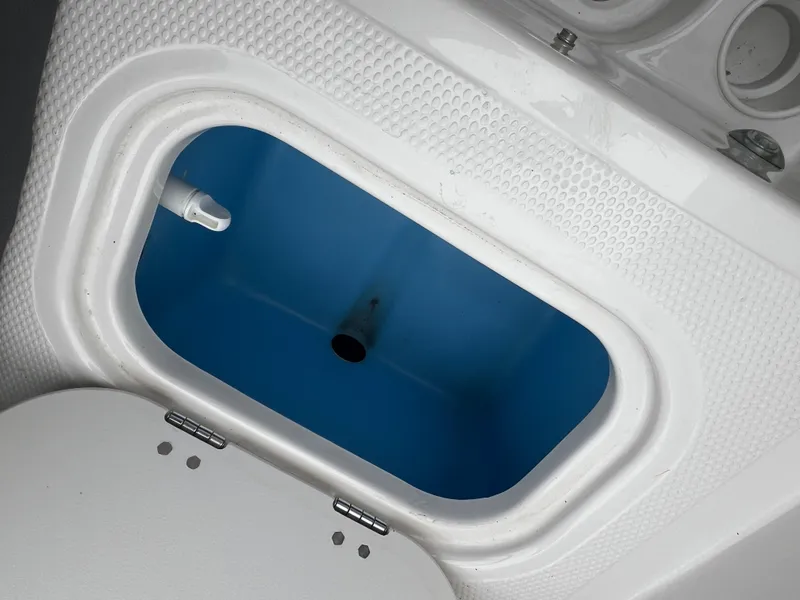 Slide: The Image of Livewell compartment in 2016 Tahoe 450 TF boat, featuring a blue interior. - 26