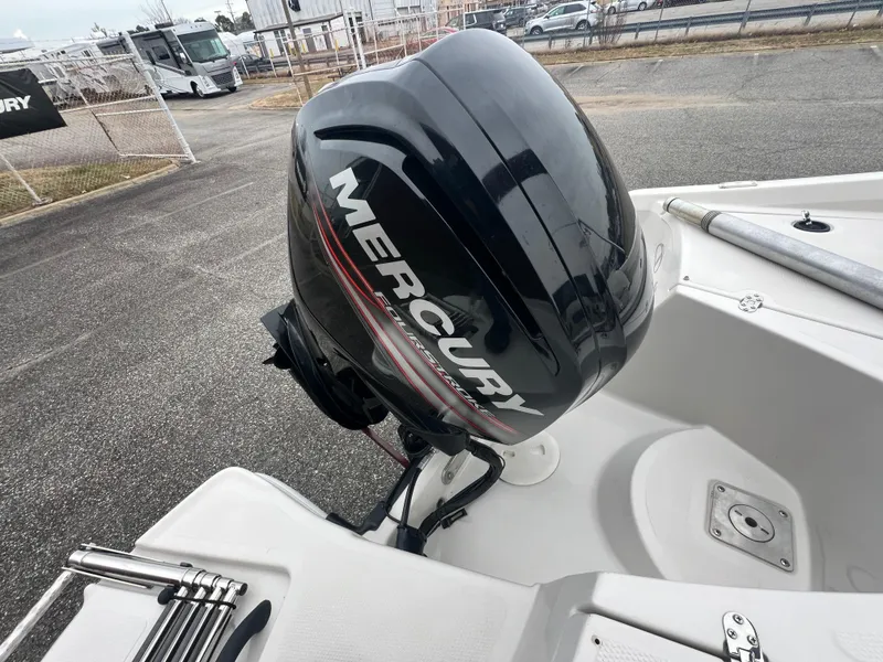 Slide: The Image of 2016 Tahoe 450 TF boat with Mercury outboard motor in a parking area. - 28