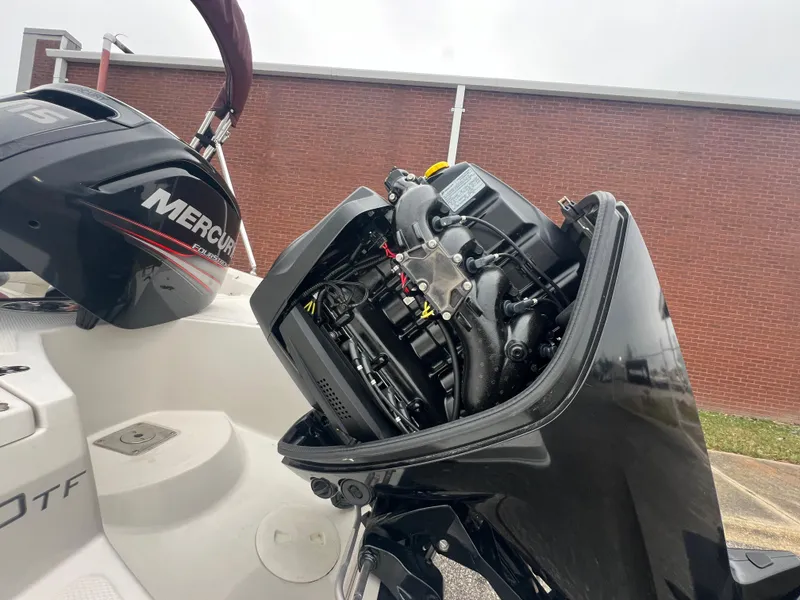 Slide: The Image of 2016 Tahoe 450 TF boat with Mercury outboard motor, engine exposed. - 30