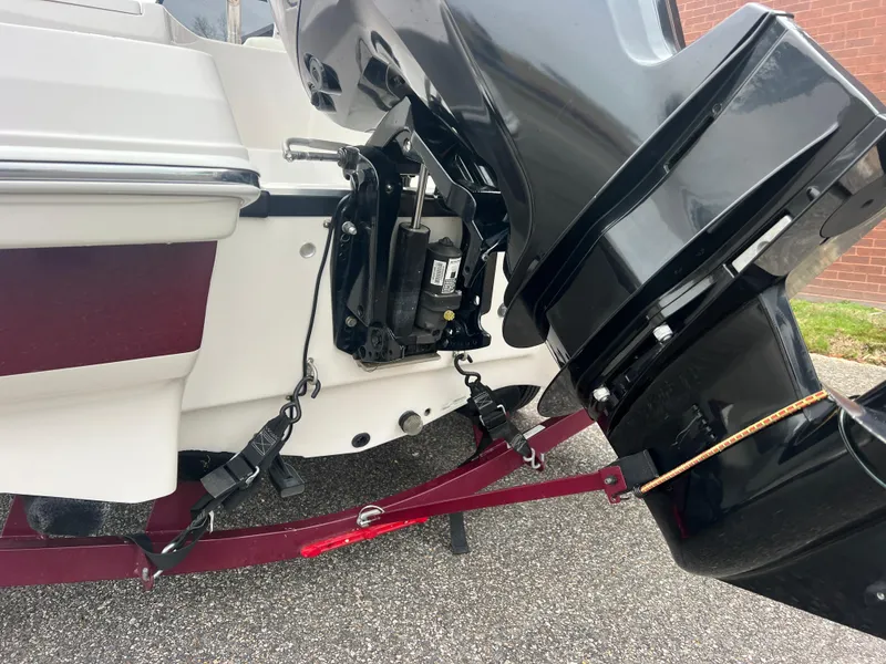 Slide: The Image of 2016 Tahoe 450 TF boat motor and trailer detail, showing engine and mounting components. - 5