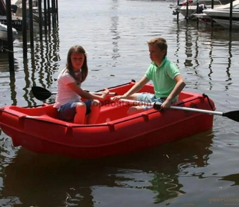 Slide: The Image of Two people rowing a red 2022 Whaly 210 boat on a calm lake. - 7