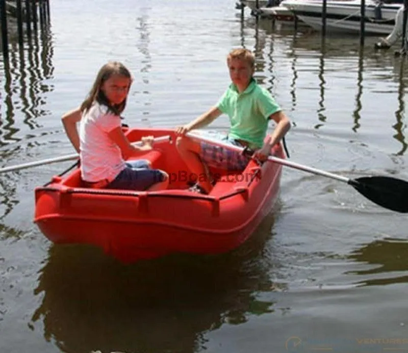 Slide: The Image of Two children rowing a red 2022 Whaly 210 boat on a calm lake. - 8