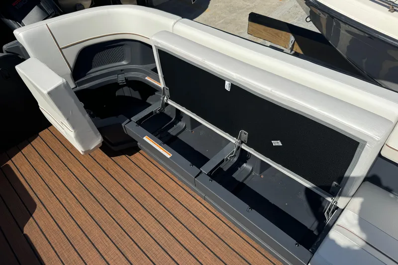 Slide: The Image of 2025 Manitou 26' Explore Navigator boat interior with open storage compartment. - 10