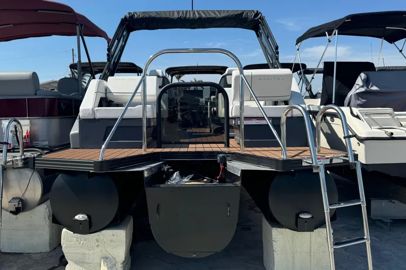 Slide: The Image of 2025 Manitou 26' Explore Navigator pontoon boat with sleek design and modern features. - 2