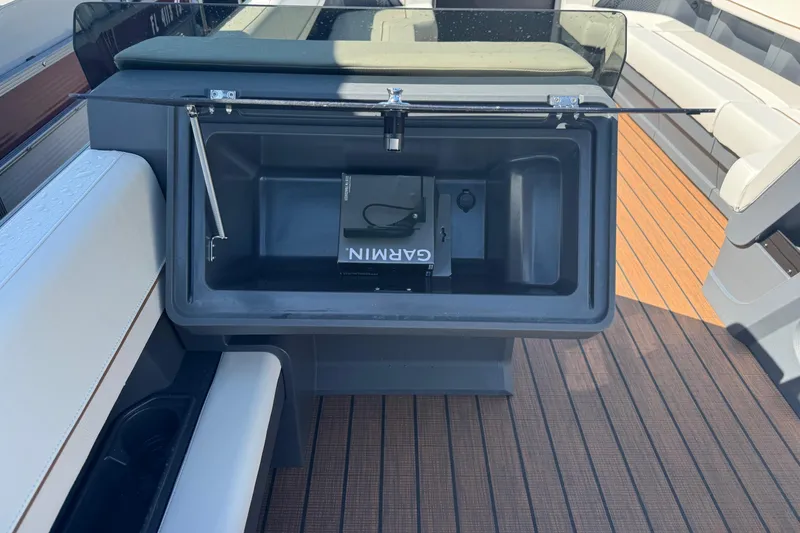 Slide: The Image of 2025 Manitou 26' Explore Navigator boat interior with Garmin storage compartment. - 6