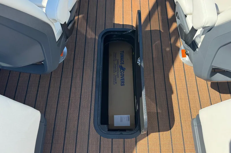 Slide: The Image of Storage compartment on 2025 Manitou 26' Explore Navigator boat deck. - 9