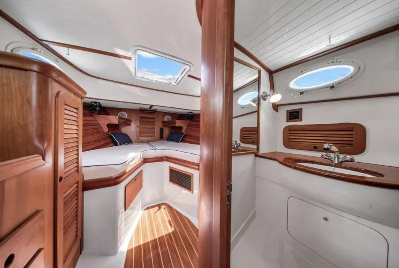 Slide: The Image of Interior of 2002 Hinckley Picnic Boat EP, featuring wood accents and cozy cabin space. - 12