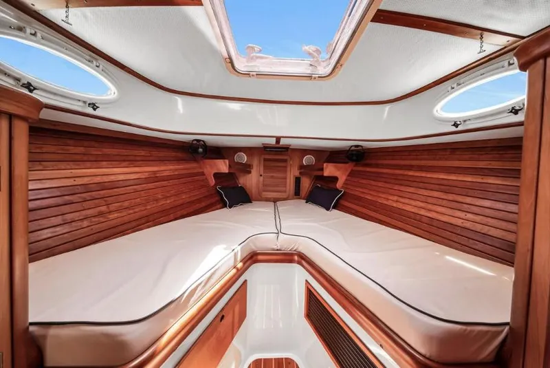 Slide: The Image of 2002 Hinckley Picnic Boat EP interior with wooden paneling and cushioned seating. - 14