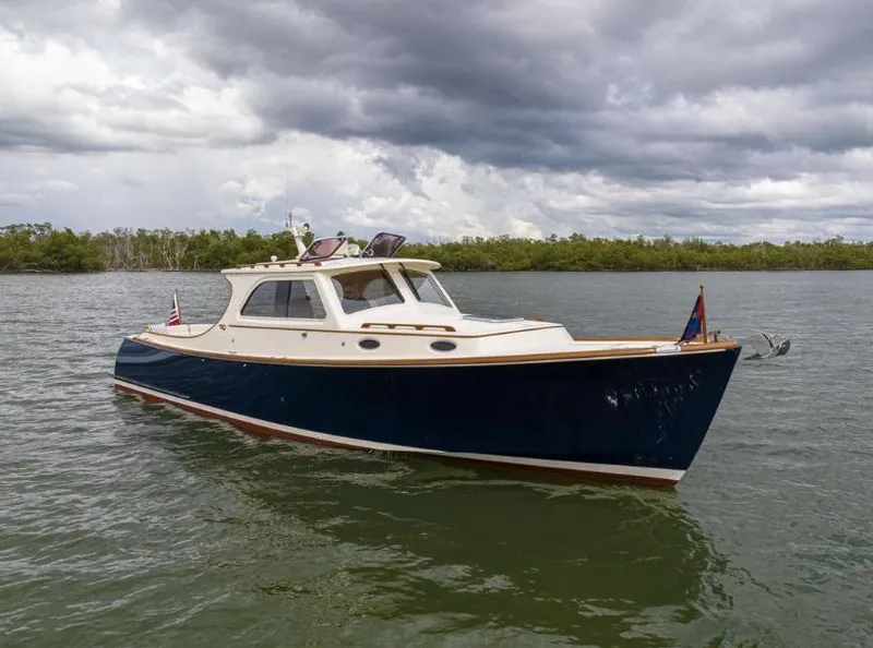 Slide: The Image of 2002 Hinckley Picnic Boat EP on water under cloudy sky. - 3