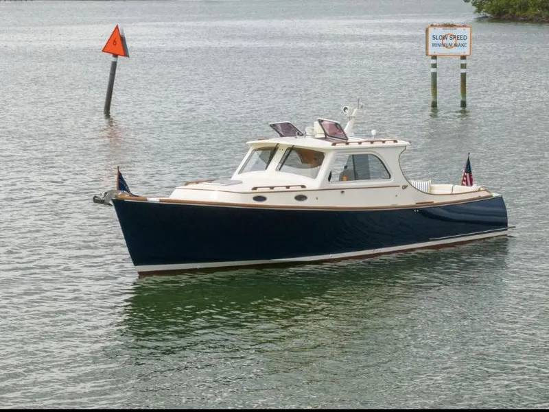 Slide: The Image of 2002 Hinckley Picnic Boat EP cruising on calm waters. - 6