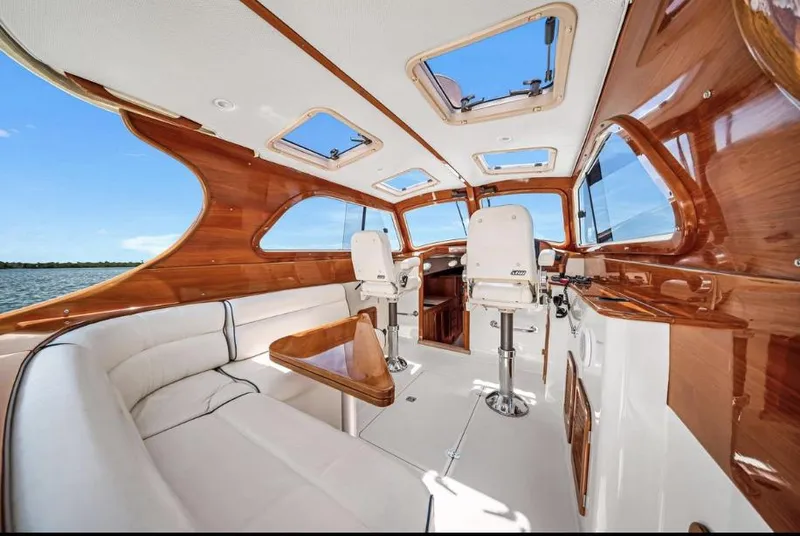 Slide: The Image of Interior of 2002 Hinckley Picnic Boat EP with elegant wood finish and plush seating. - 7