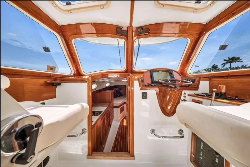 Slide: The Image of 2002 Hinckley Picnic Boat EP interior with wooden accents and modern navigation equipment. - 8