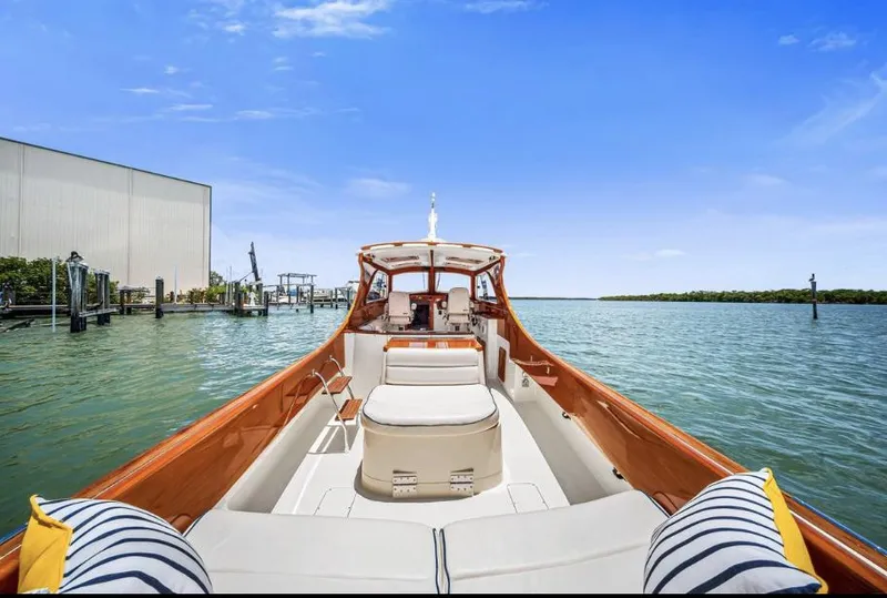 Slide: The Image of 2002 Hinckley Picnic Boat EP on calm water, clear sky, dockside view. - 9