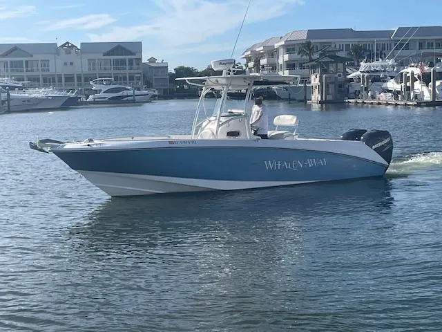 The Image of 2008 Boston Whaler 270 Outrage boat on water near marina. - 0