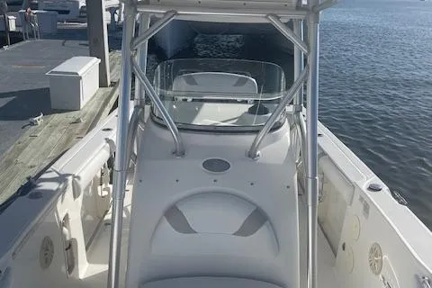 Slide: The Image of 2008 Boston Whaler 270 Outrage boat docked by the water. - 10