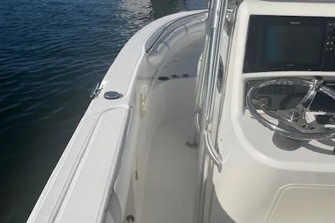 Slide: The Image of 2008 Boston Whaler 270 Outrage boat helm and deck view on water. - 11