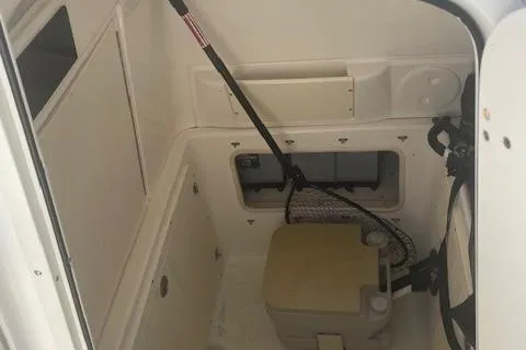 Slide: The Image of 2008 Boston Whaler 270 Outrage interior storage compartment with fishing gear. - 18