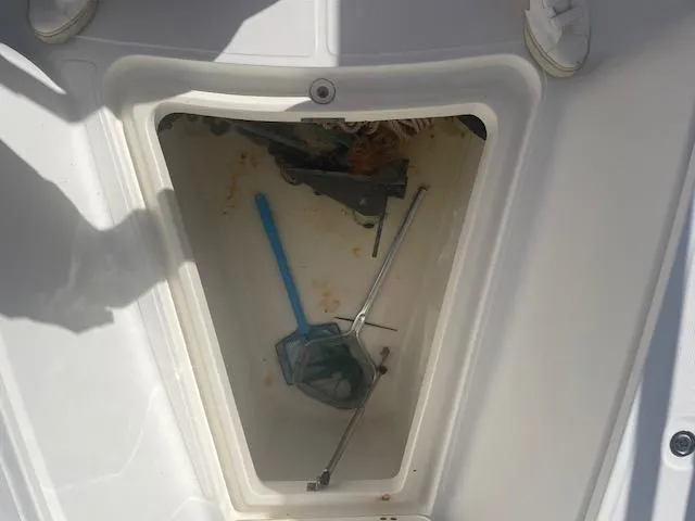 Slide: The Image of Storage compartment of a 2008 Boston Whaler 270 Outrage with tools and equipment. - 20