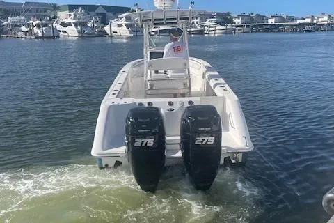 Slide: The Image of 2008 Boston Whaler 270 Outrage with twin 275 engines in a marina setting. - 4