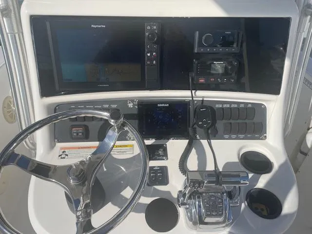 Slide: The Image of 2008 Boston Whaler 270 Outrage helm with navigation and control systems. - 7