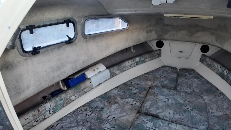 Slide: The Image of Interior cabin of a 1996 Grady-White Voyager boat with cushioned seating. - 13